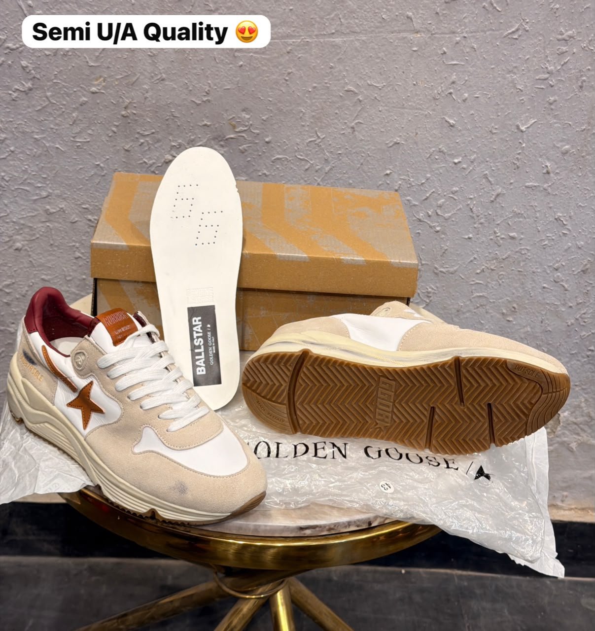 Beige and white low-top sneakers with brown star detailing, layered panels, and a chunky cream sole