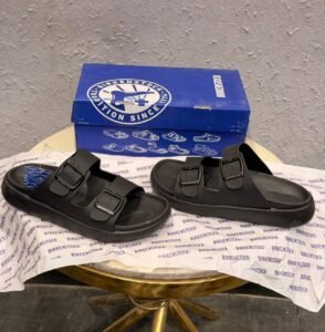 Black double-buckle slides for men with a contoured footbed and minimalist slip-on design