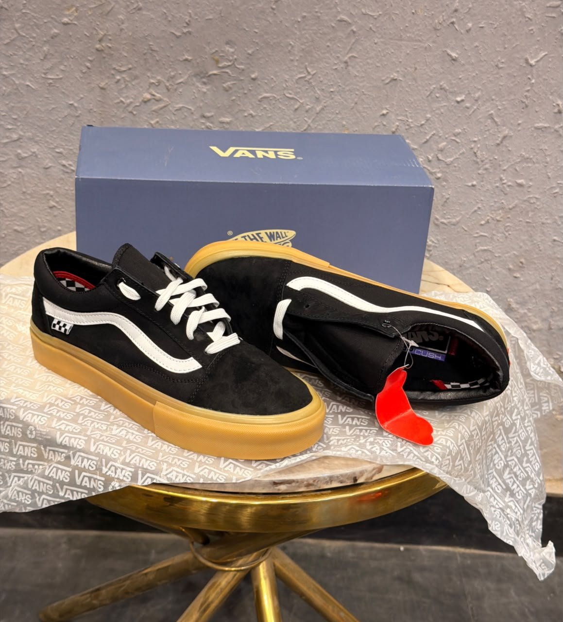 Black Low-Top Sneakers – Gum Sole Skate Style (3) Black low-top sneakers with white side detailing, white laces, checkerboard-inspired heel accents, and a gum-coloured sole