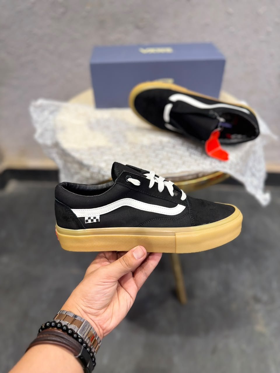 Black Low-Top Sneakers – Gum Sole Skate Style (4) Black low-top sneakers with white side detailing, white laces, checkerboard-inspired heel accents, and a gum-coloured sole