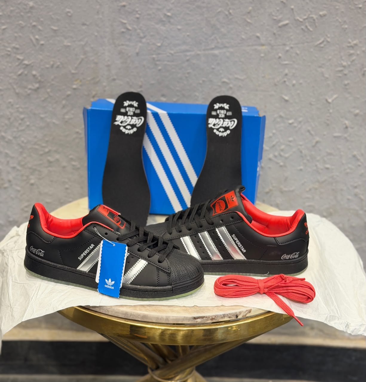 Black Retro Sneakers – Red Accent Shell-Toe Streetwear Edition (3) Black retro low-top sneakers with silver-toned stripes, red accents, a textured shell-shaped toe, and a green-toned outsole