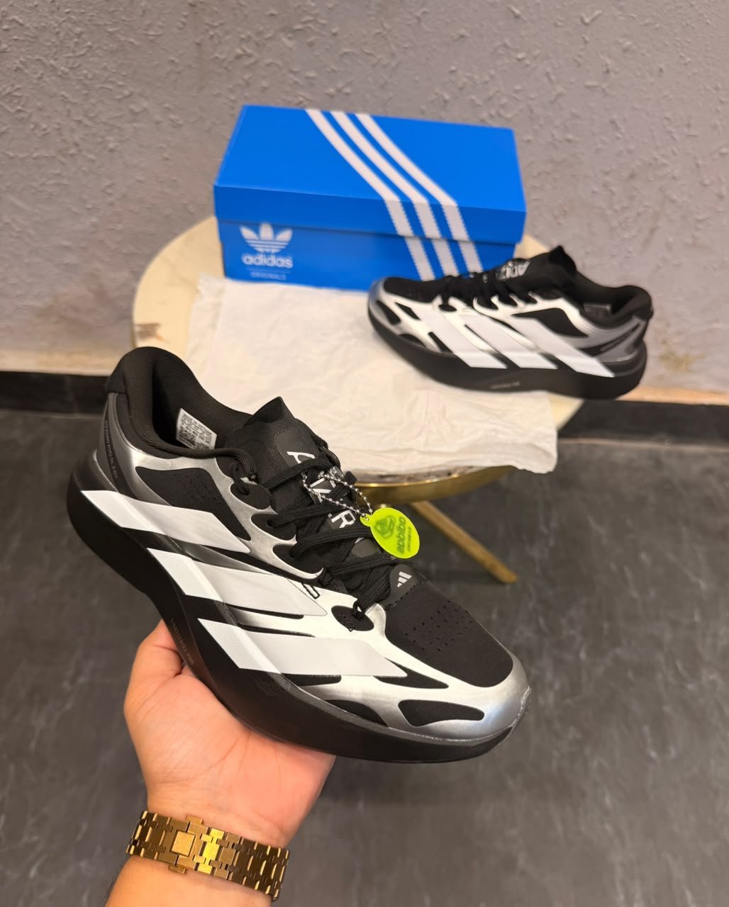 Black Silver Running Sneakers – Performance-Inspired Streetwear Edition (1) Black and silver low-top sneakers with white side stripes, perforated detailing, and a sculpted dark outsole