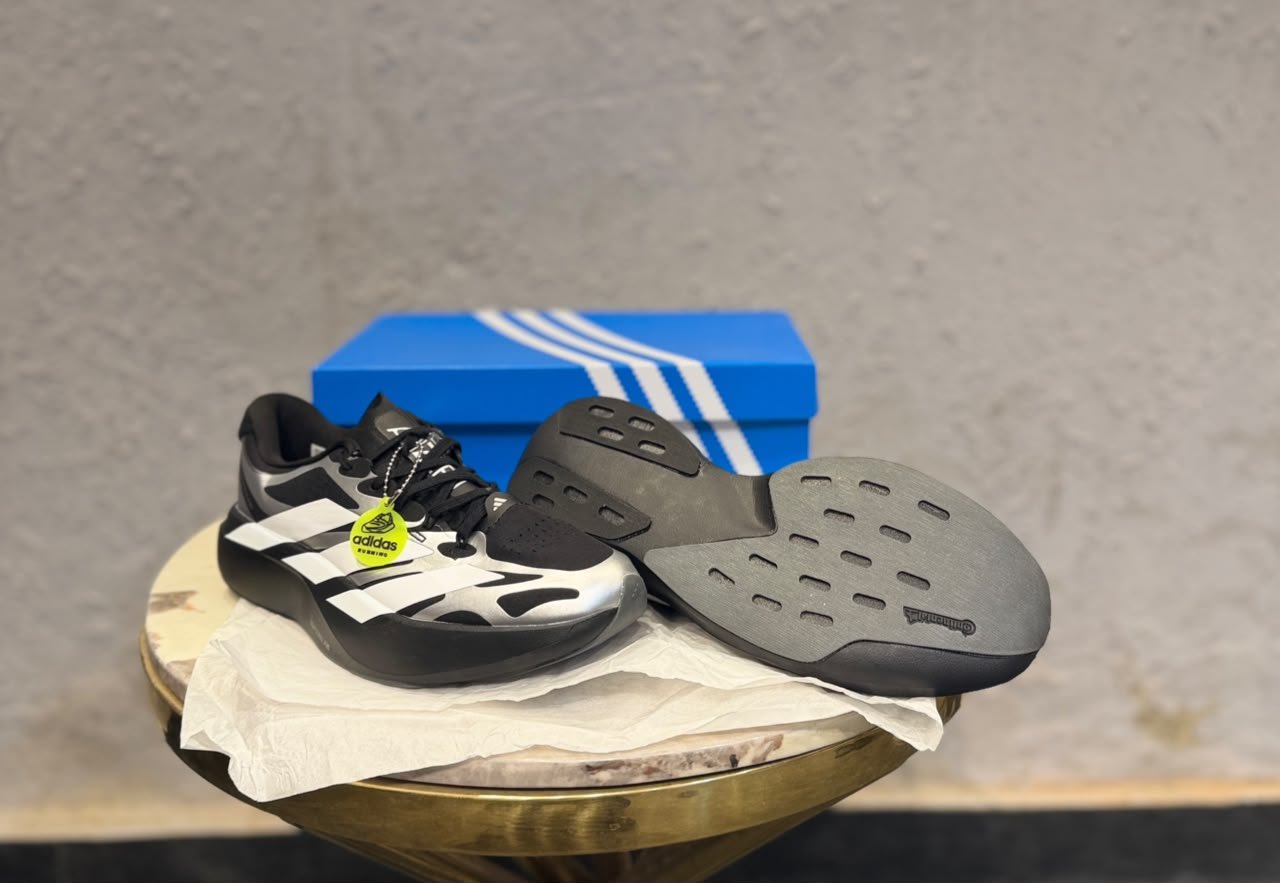 Black Silver Running Sneakers – Performance-Inspired Streetwear Edition (3) Black and silver low-top sneakers with white side stripes, perforated detailing, and a sculpted dark outsole