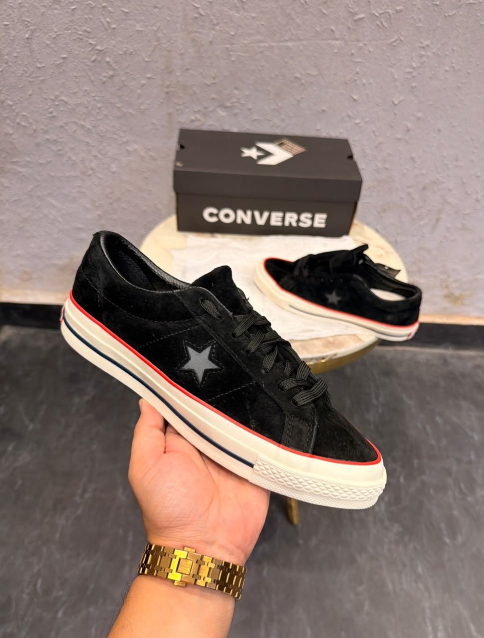 Black Suede Sneakers – Red Accent Retro Skate Edition (1) Black low-top sneakers with a textured suede-look upper, star-shaped side detail, cream sole, and red accent stripe