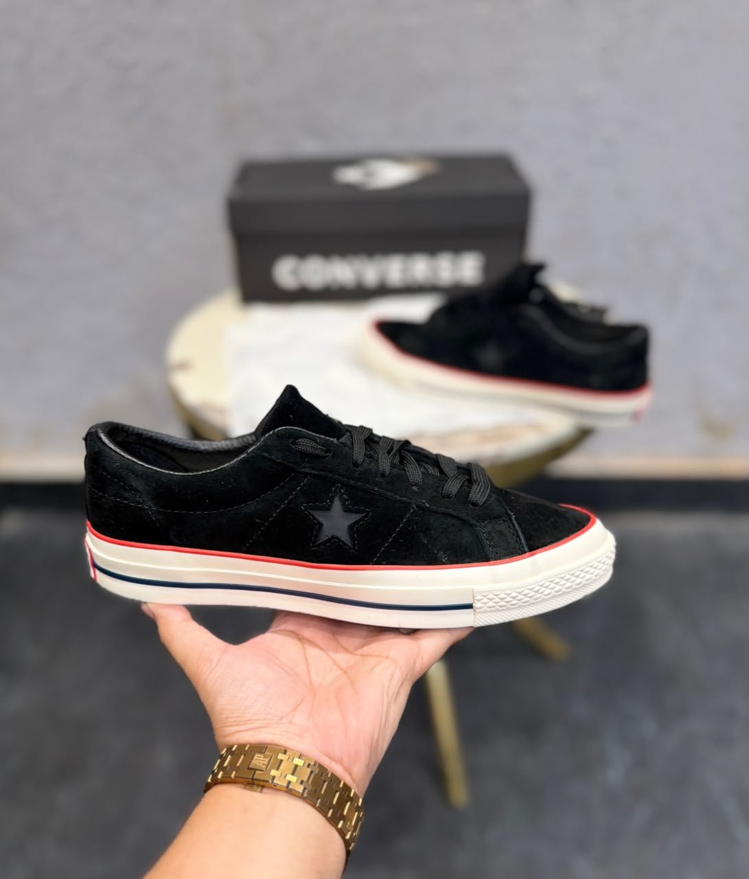 Black Suede Sneakers – Red Accent Retro Skate Edition (4) Black low-top sneakers with a textured suede-look upper, star-shaped side detail, cream sole, and red accent stripe