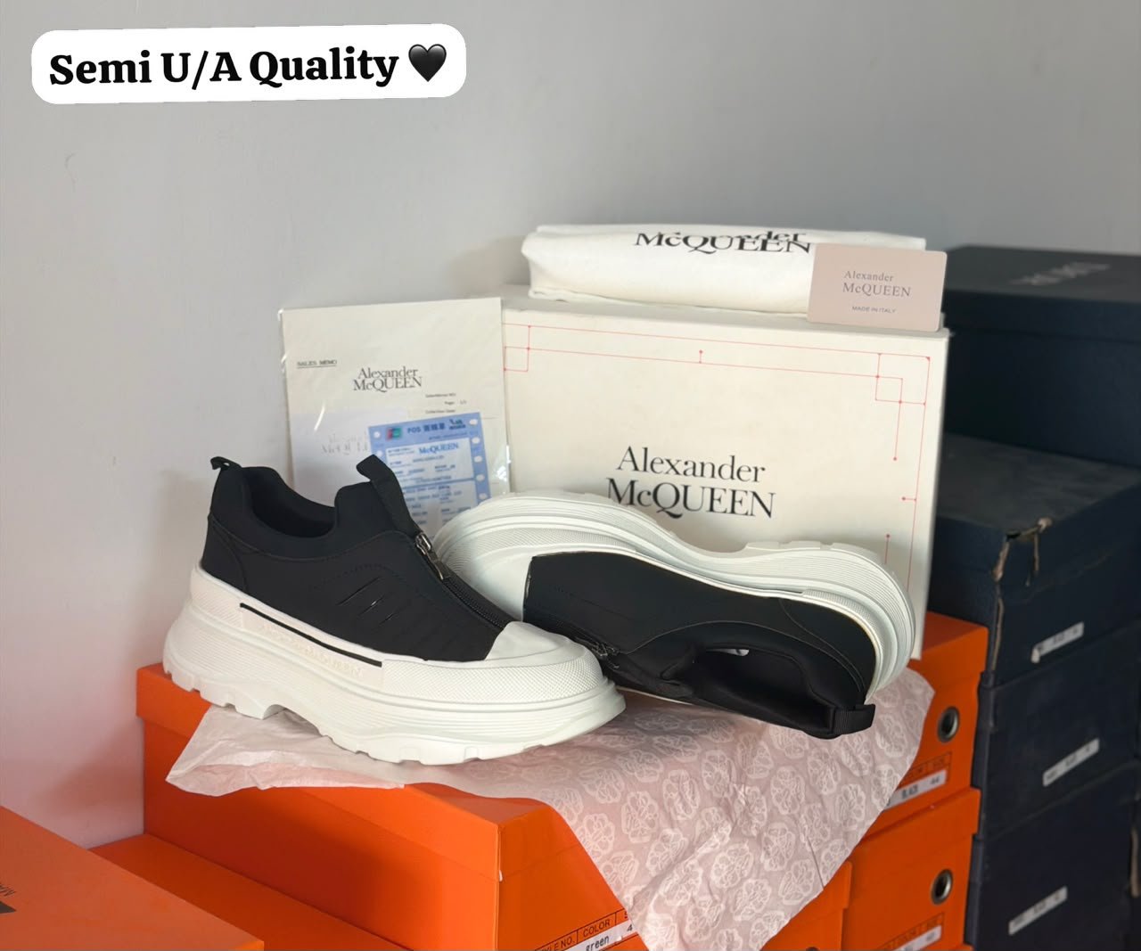 Black Zip Sneakers – Contemporary Luxury Streetwear (3) Black zip sneakers featuring a minimalist black upper, front zipper closure, and chunky white outsole with geometric tread.