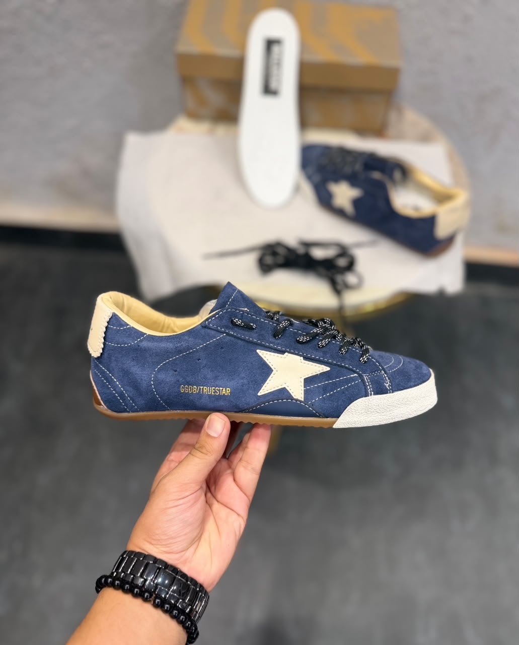 Blue denim-style sneakers with a cream star detail, lace-up fastening, and gum-style outsole