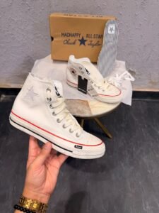 Cream high-top sneakers with red midsole piping, dark brown outsole, star-shaped side detail, and extra white laces