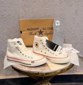 Cream high-top sneakers with red midsole piping, dark brown outsole, star-shaped side detail, and extra white laces