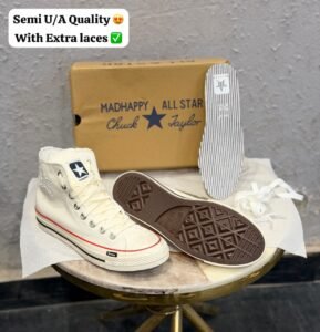 Cream high-top sneakers with red midsole piping, dark brown outsole, star-shaped side detail, and extra white laces