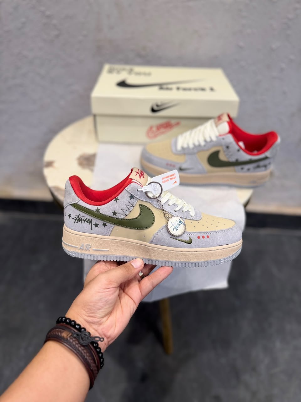 Grey Red Olive Sneakers – Custom Retro Street Style (4) Grey low-top sneakers with olive-green accents, red lining, cream toe panels, decorative star graphics, and a grey circular-patterned outsole