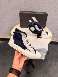 Obsidian navy high top sneakers with light grey overlays, cream laces, contrast stitching, and an off-white sole