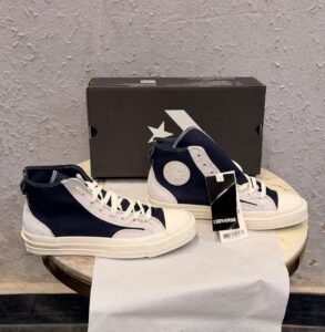 Obsidian navy high top sneakers with light grey overlays, cream laces, contrast stitching, and an off-white sole