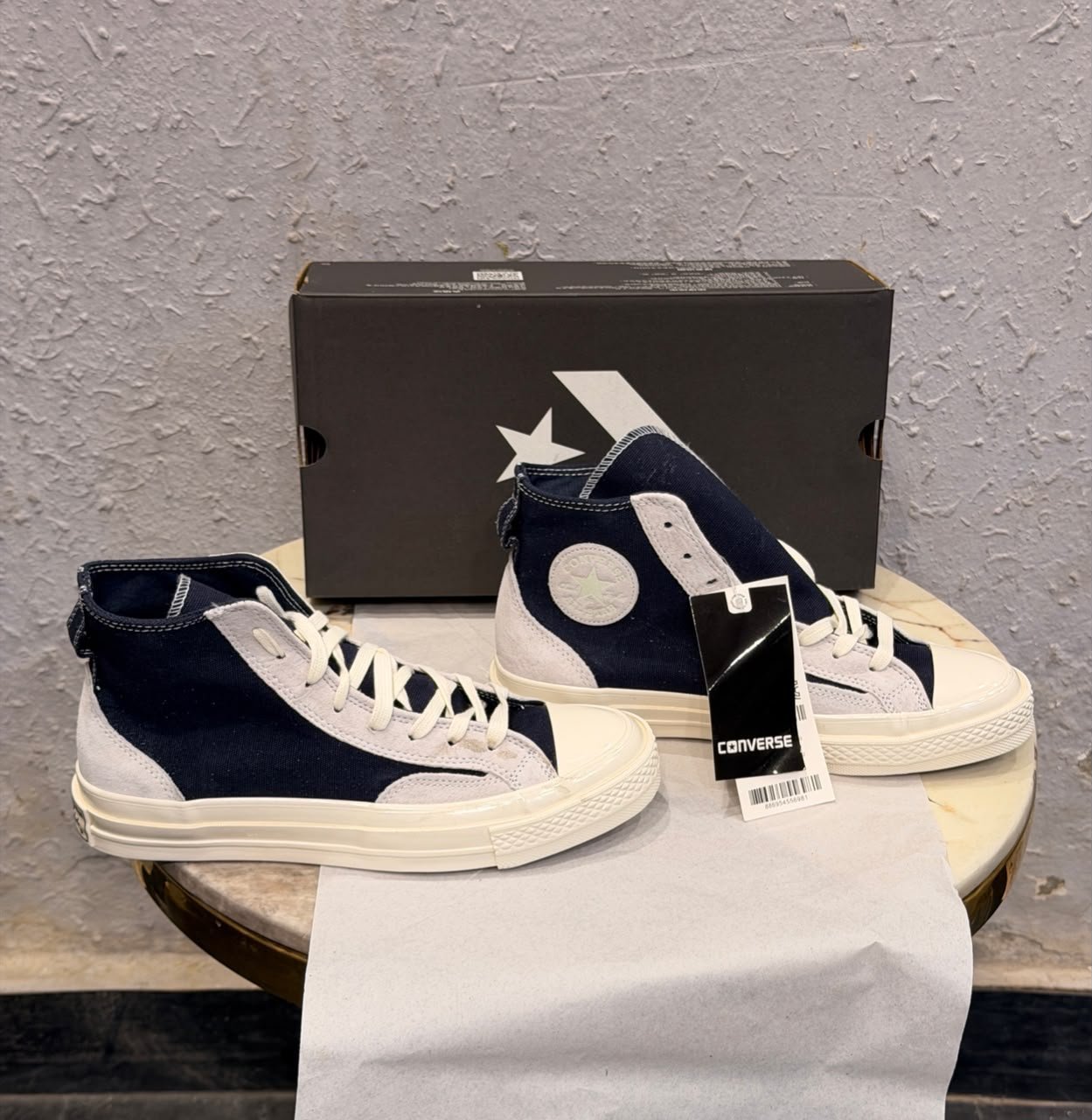 Obsidian navy high top sneakers with light grey overlays, cream laces, contrast stitching, and an off-white sole