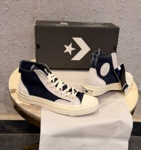 Obsidian navy high top sneakers with light grey overlays, cream laces, contrast stitching, and an off-white sole