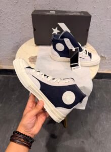 Obsidian navy high top sneakers with light grey overlays, cream laces, contrast stitching, and an off-white sole