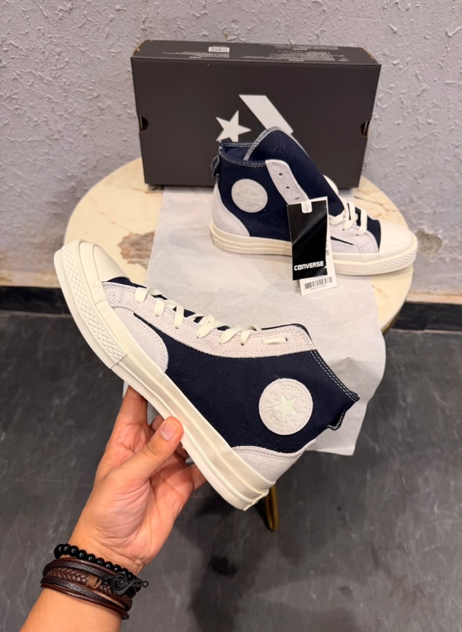 Obsidian navy high top sneakers with light grey overlays, cream laces, contrast stitching, and an off-white sole