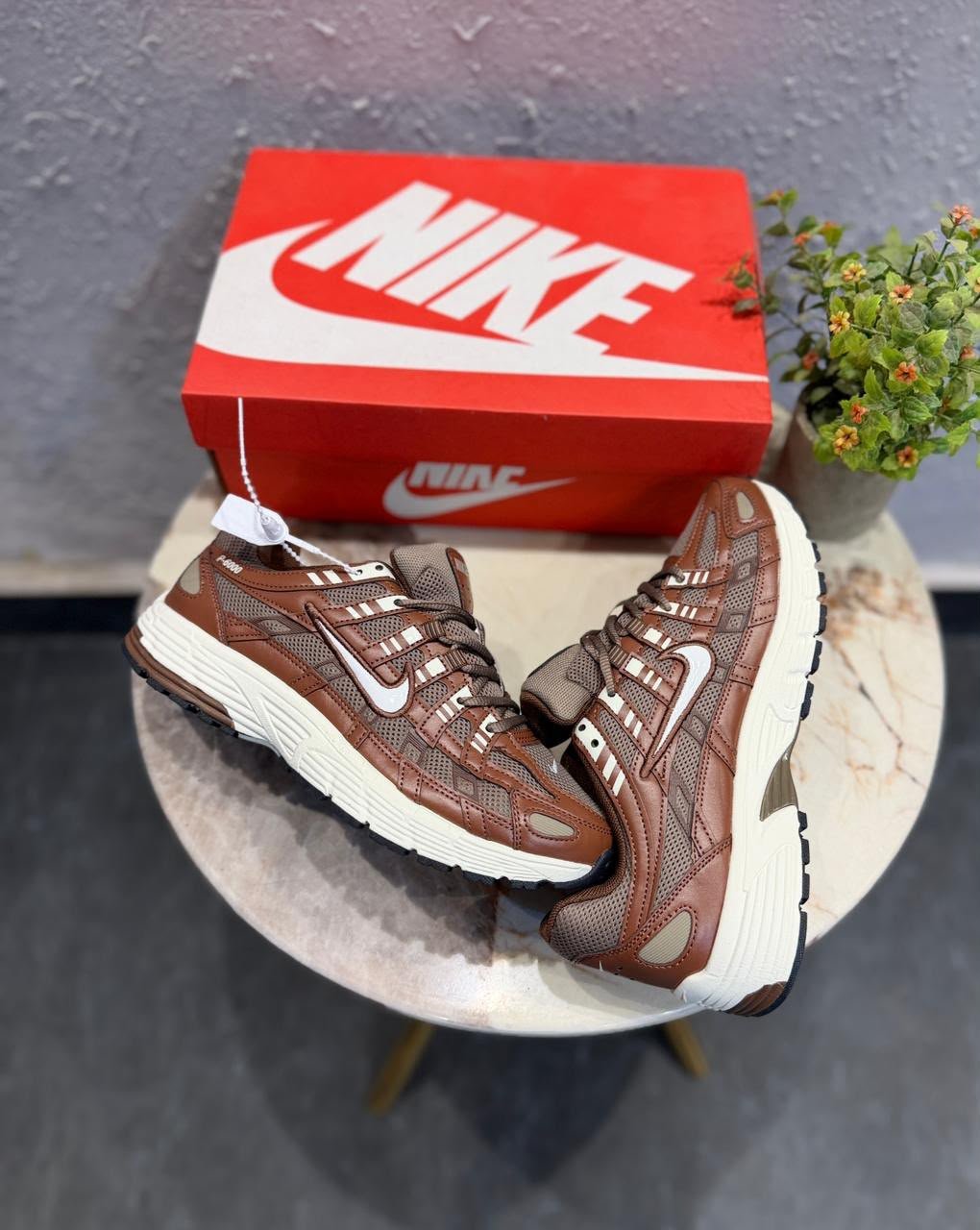 Brown and white P-6000 running-inspired sneakers with layered mesh-style panels and a cream-coloured sole