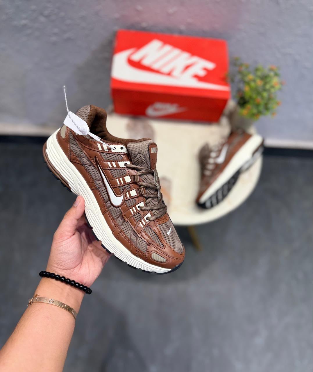 Brown and white P-6000 running-inspired sneakers with layered mesh-style panels and a cream-coloured sole