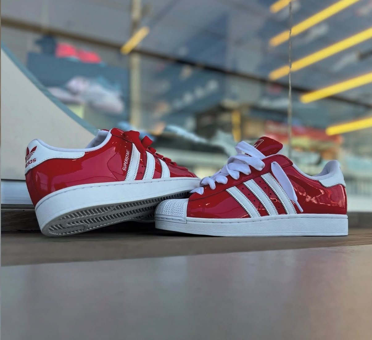Red White Retro Sneakers – Classic Shell-Toe Streetwear Edition (4) Red and white low-top sneakers with contrasting white side stripes, matching laces, and a textured shell-shaped toe cap