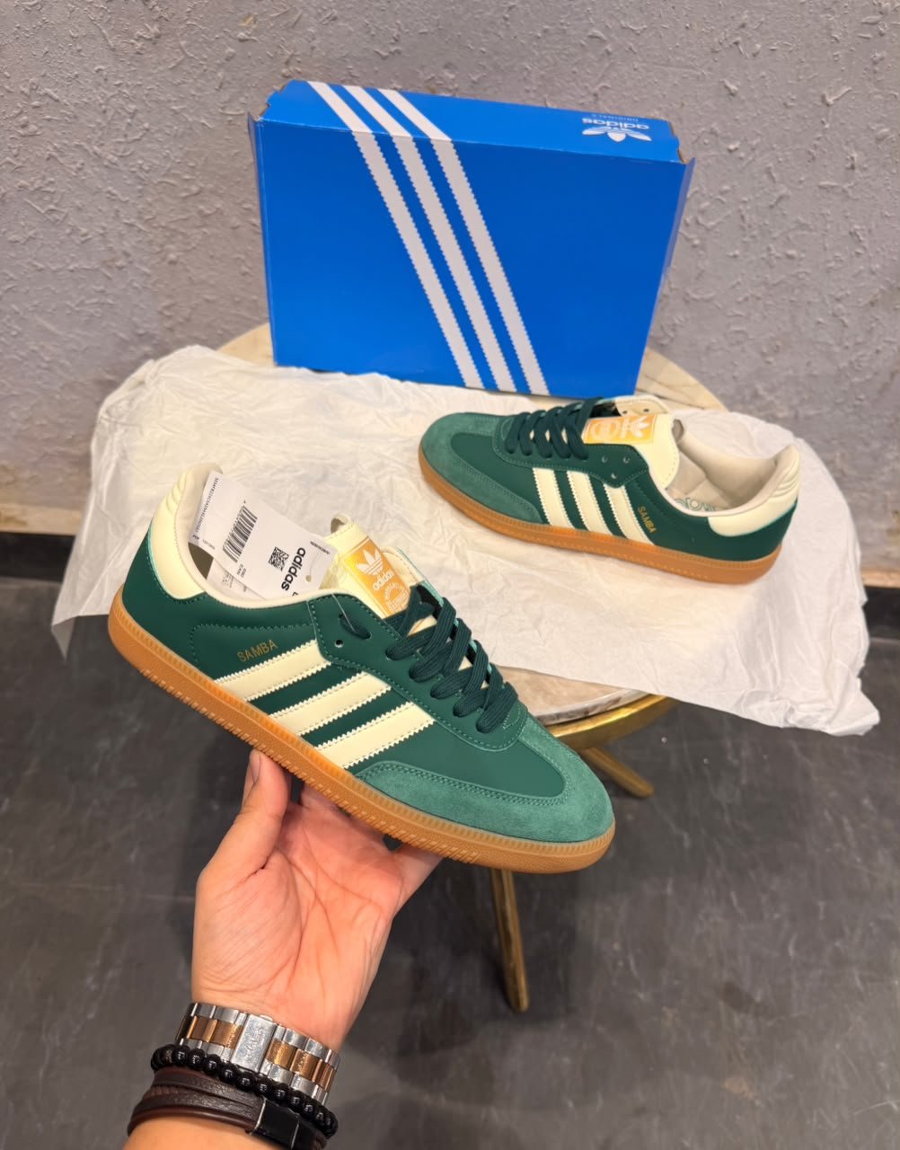 Green retro low-top sneakers with cream stripes, dark green laces, and a gum-colored sole