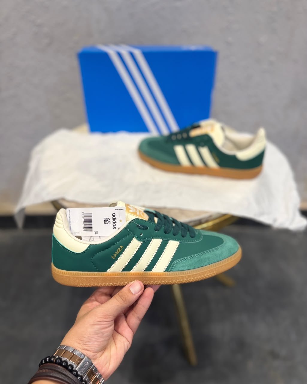 Green retro low-top sneakers with cream stripes, dark green laces, and a gum-colored sole