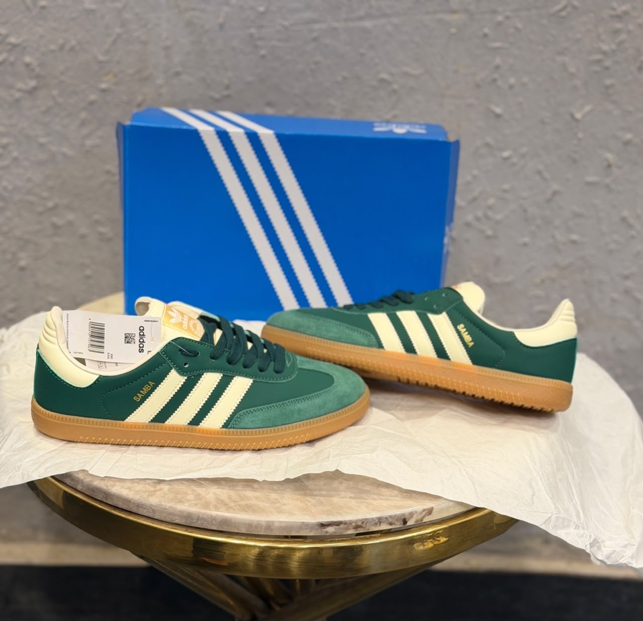 Green retro low-top sneakers with cream stripes, dark green laces, and a gum-colored sole