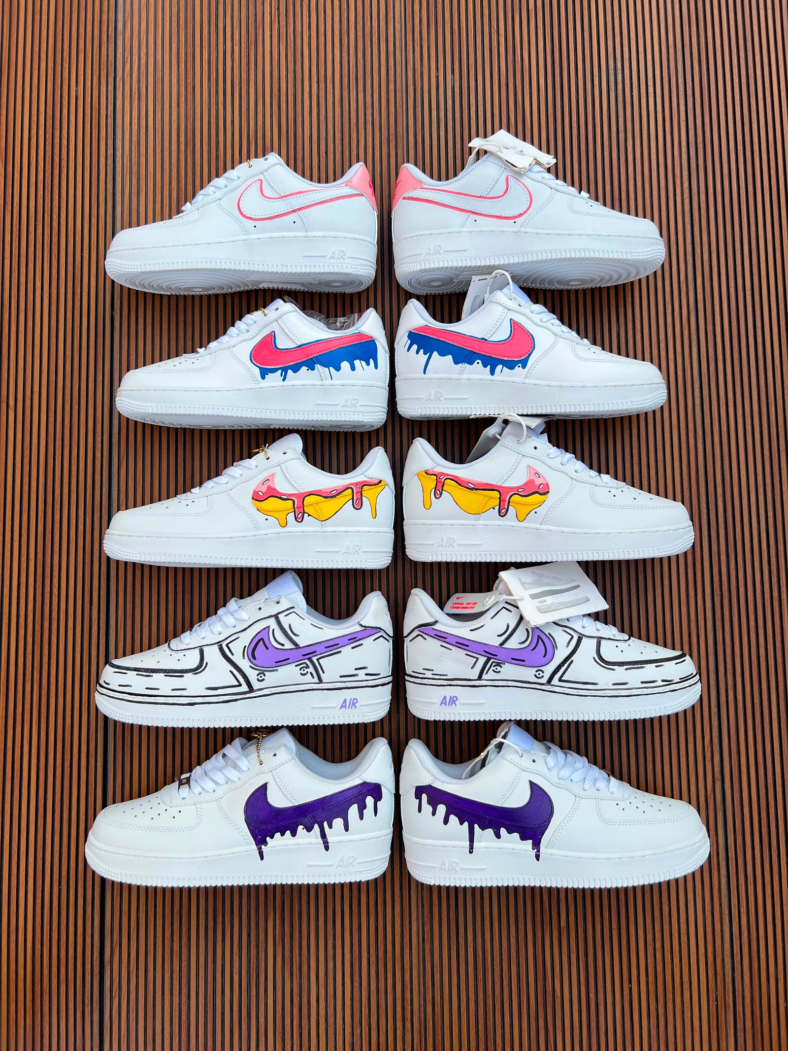 White Custom Sneakers – Multicolour Drip Art Edition (11) White custom low-top sneakers featuring colourful drip-art graphics in pink, blue, yellow, and purple
