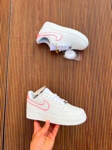 White custom low-top sneakers featuring colourful drip-art graphics in pink, blue, yellow, and purple