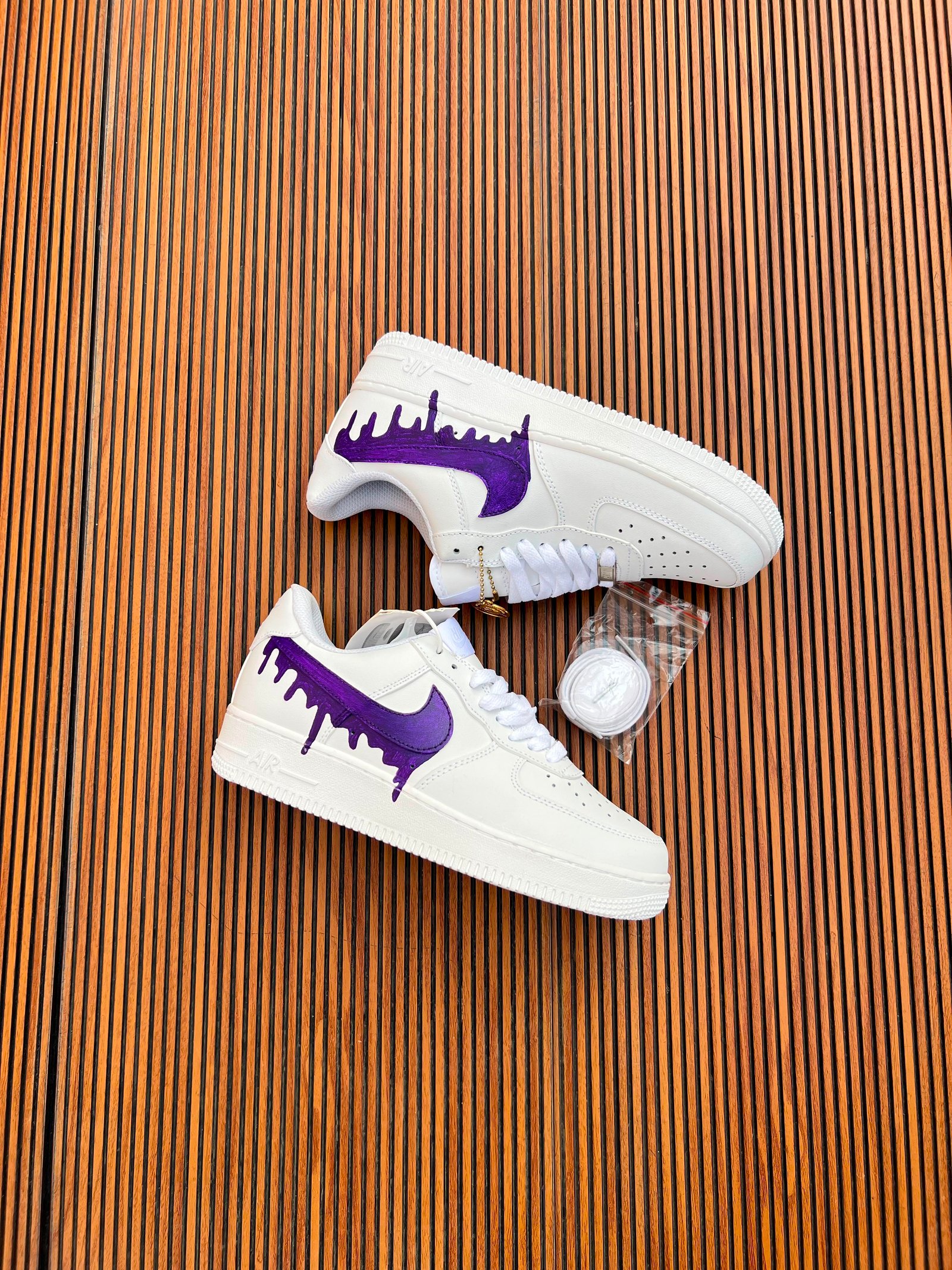 White Custom Sneakers – Multicolour Drip Art Edition (6) White custom low-top sneakers featuring colourful drip-art graphics in pink, blue, yellow, and purple