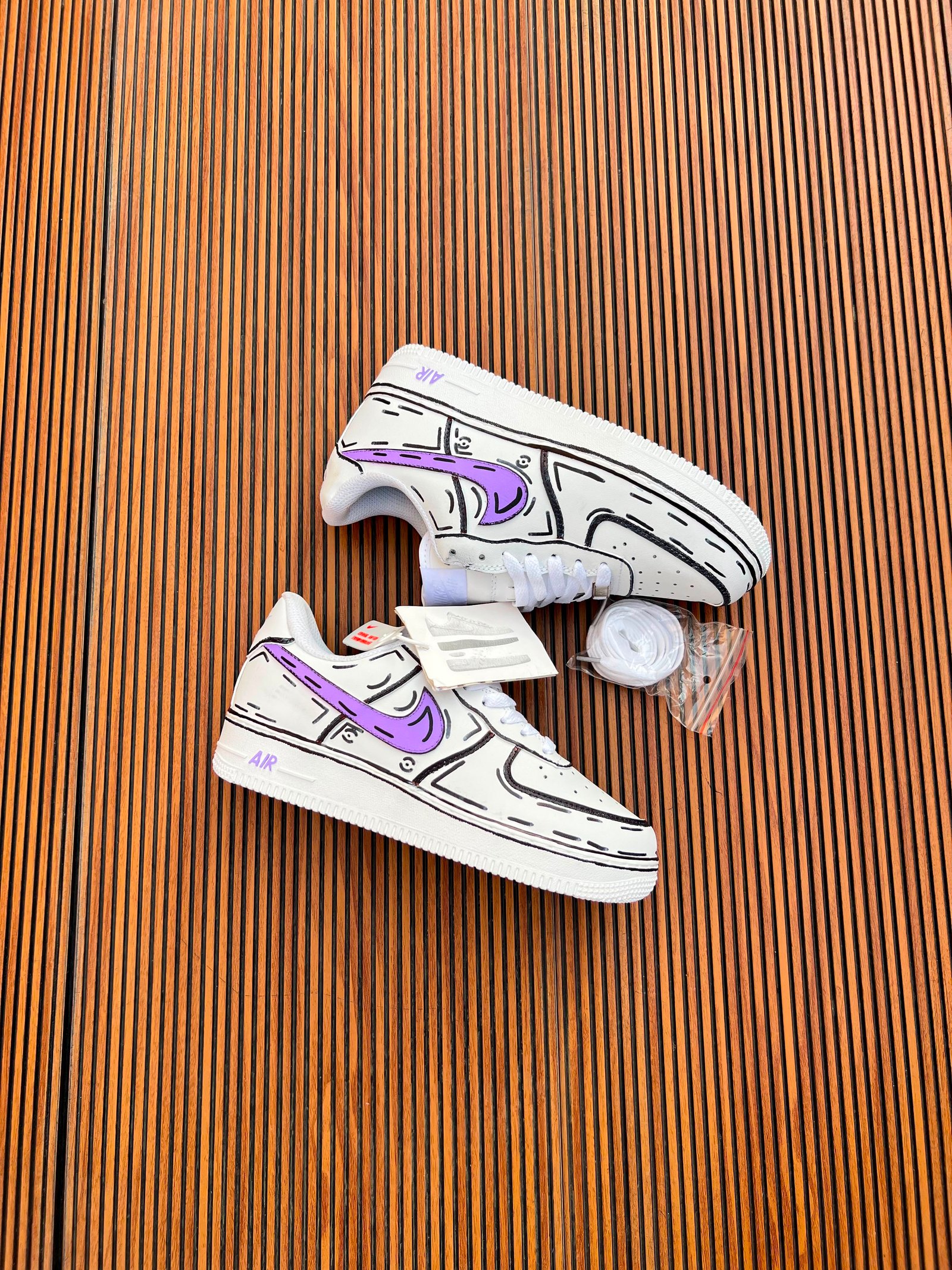 White Custom Sneakers – Multicolour Drip Art Edition (8) White custom low-top sneakers featuring colourful drip-art graphics in pink, blue, yellow, and purple