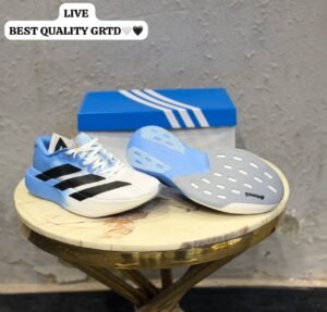 White and sky blue athletic-style sneakers with black side stripes, lace-up closure, and a sculpted white and blue sole