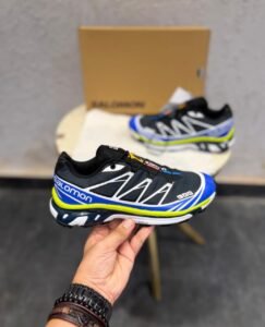 Black blue and neon yellow XT Ghost trail-inspired sneakers with geometric overlays and rugged tread outsole